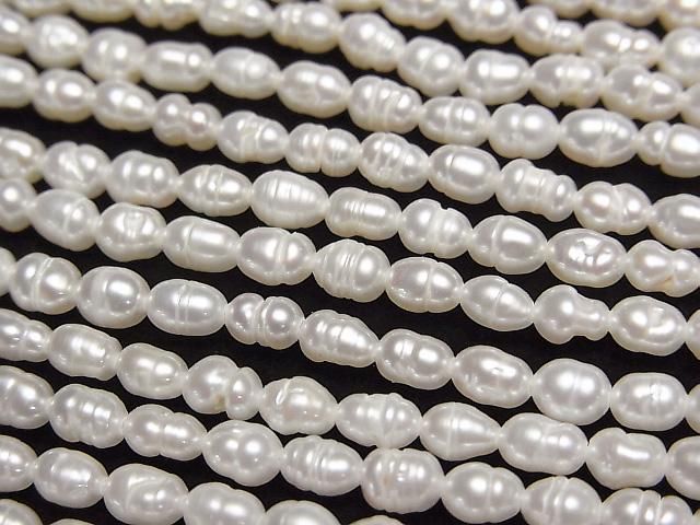 【動画】淡水真珠AA 縞入りライス4×3×3mm ホワイト 1連(約33cm)の画像